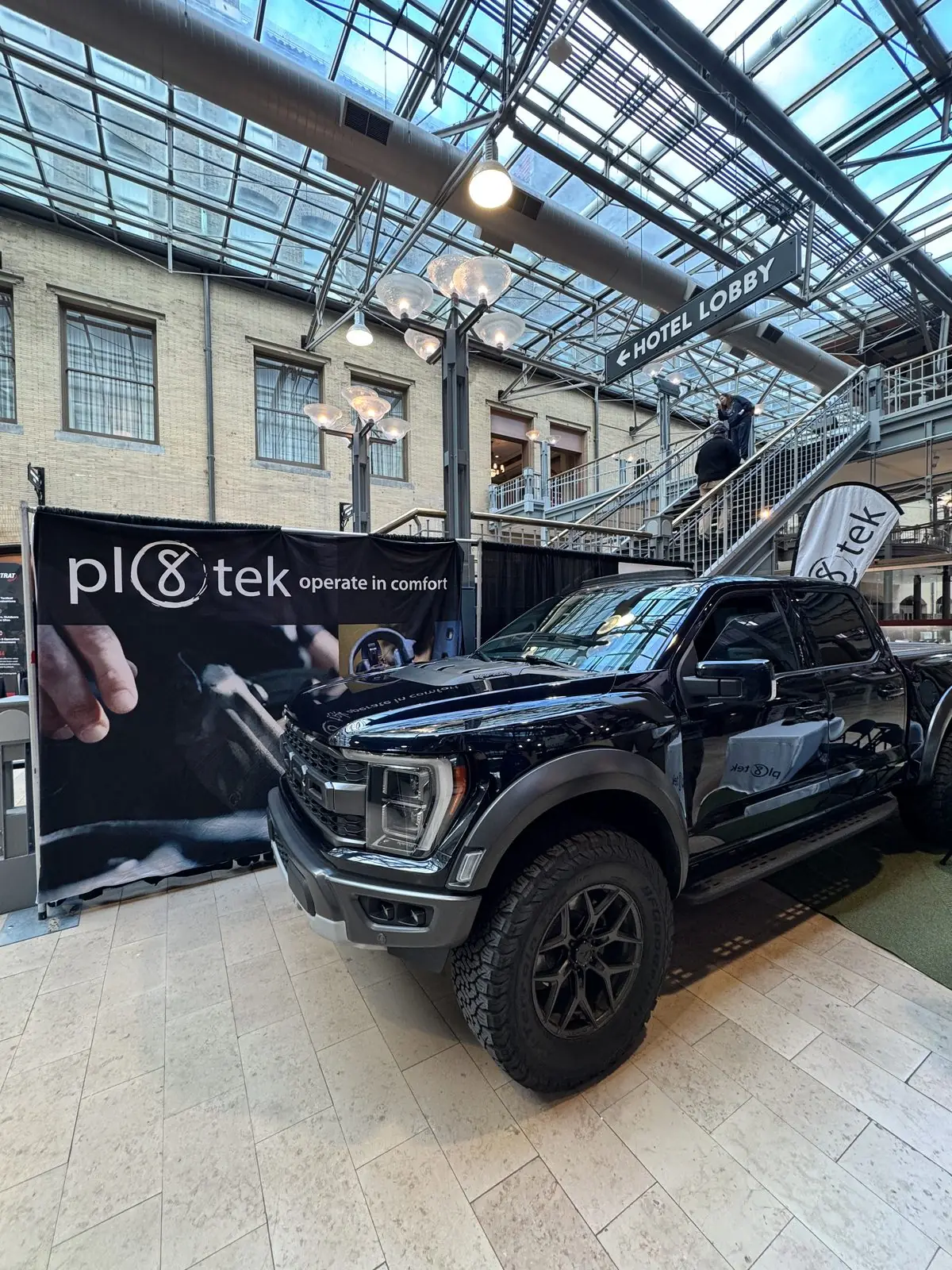 The display truck in front of the Pl8tek operate-in-comfort banner.