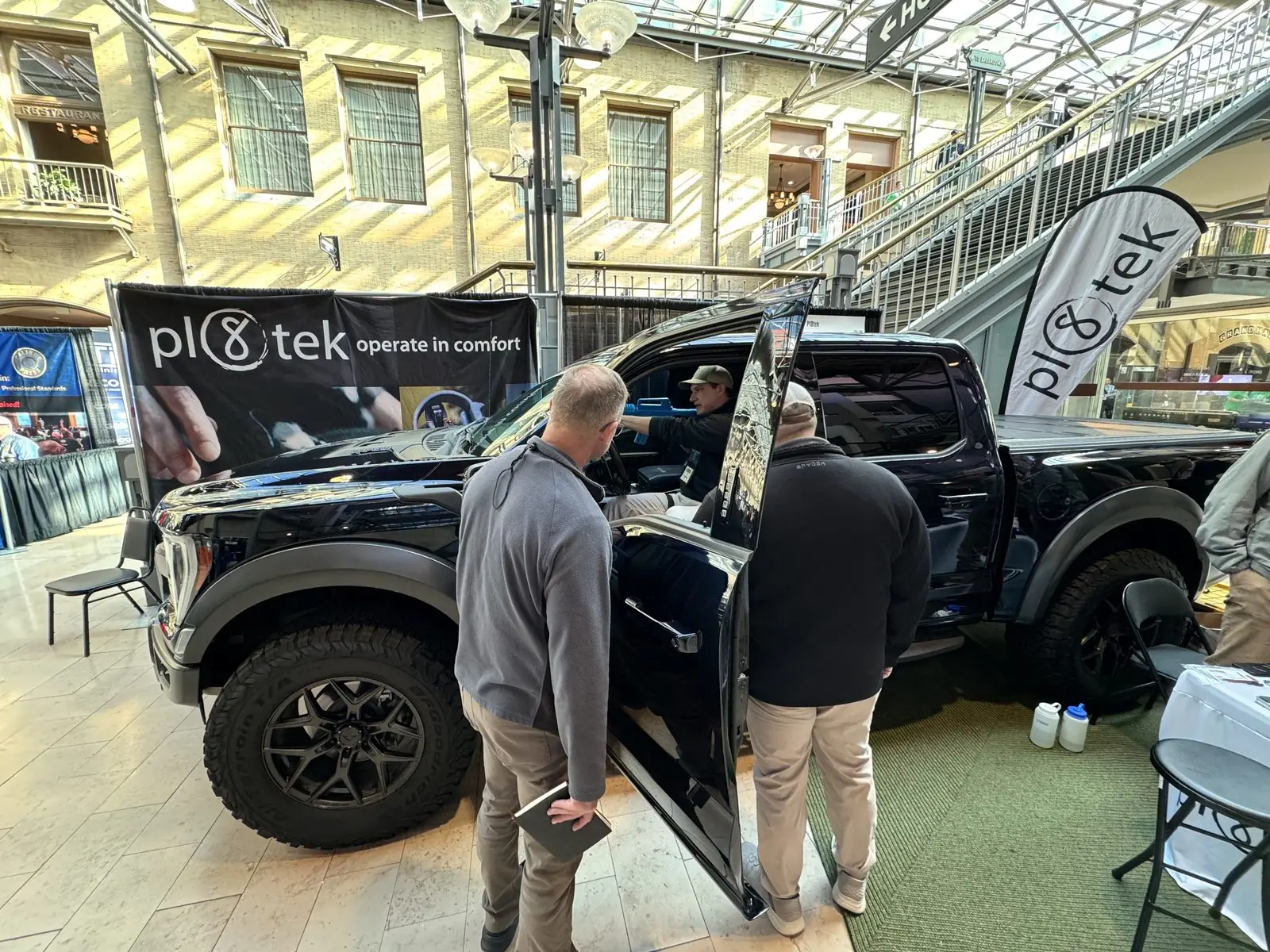 Officers examining the StandA.R.D. mount through the open door of the display truck.