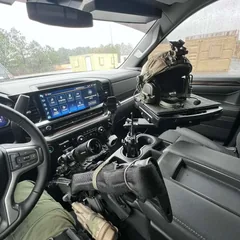 StandA.R.D. mount securing a wrapped rifle at the console of a Chevy patrol truck